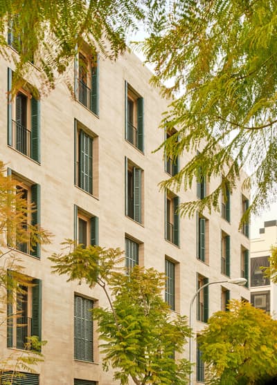 Architectural project - vertical windows, vertical rhythm, urban greenery, resilience, facade, urban building, symmetrical layout, green shutters, architectural metalwork, stone facade, limestone look, window detailing, city greenery, mixed use, sustainability, minimal design, calming atmosphere, natural materials, metal, warm tones, urban landscape, green, neutral tones, city architecture, outdoor setting, urban planning, beige, building facade, minimalist facade, modern aesthetic, golden, eco friendly, contemporary design, passive cooling, tranquil setting, geometric design, modern facade, clean lines, stone, earthy tones, greenery, residential building, sustainable facade, urban nature, facade design, architectural harmony, lush surroundings, modern urban, exterior cladding