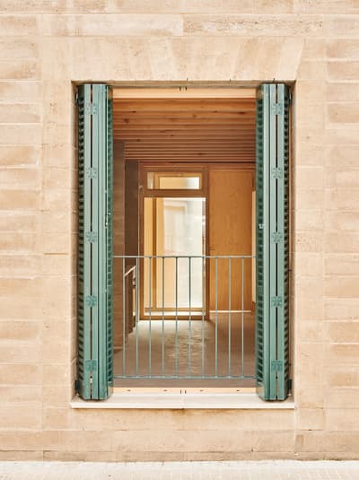 Architectural project - green shutters, terrace, balcony, open shutter, exposed timber, sand tone, natural facade, apartment entrance, clean architecture, urban dwelling, ecological home, interior transition, architectural detail, wood, timber, sustainable design, glass, warm tones, eco design, green, neutral tones, daylight, beige, light wood, rustic charm, light brown, minimalist design, exterior, cozy space, rammed earth, natural material, earthy texture, modern rustic, biophilic design, passive house, natural ventilation, timber cladding, textured wall, wooden interior, wood walls, inviting space, warm atmosphere, clay, Mediterranean style, exterior view, residential space, bright interior, simple lines