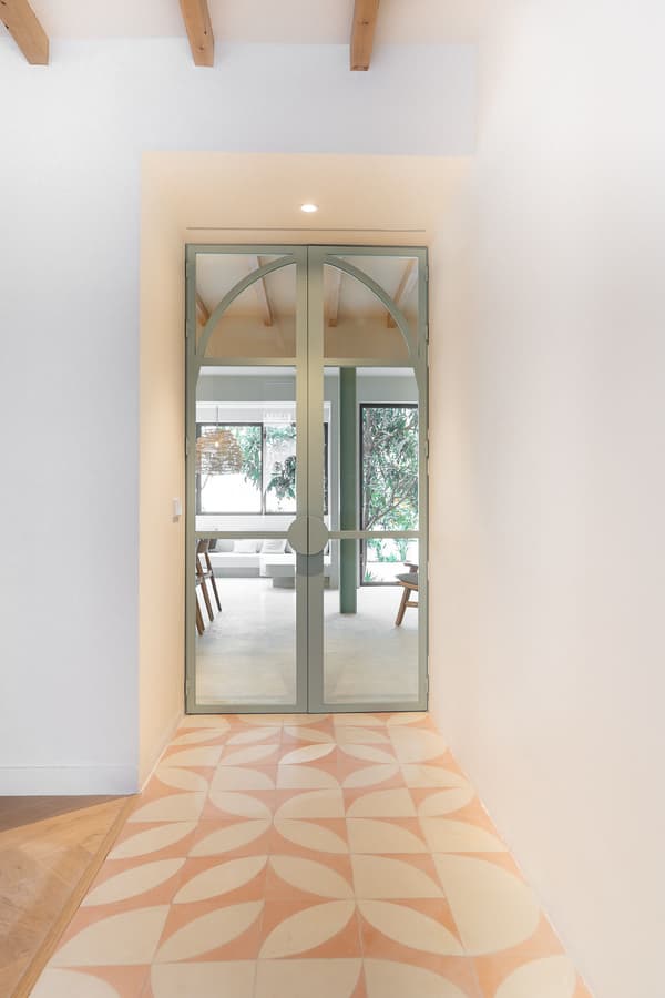 Architectural project - indoor greenery, simple aesthetic, modern entrance, light wood floor, patterned tiles, timber details, arched door, open entrance, geometric tiles, pastel pink, pastel tones, wood, natural light, sustainable design, glass, warm tones, green, neutral tones, exposed beams, daylight, beige, eco friendly, contemporary design, neutral palette, minimalist design, Scandinavian vibe, clean lines, white, cozy vibe, inviting entrance, airy space, bright interior, glass door, soft colors, welcoming space, hallway, indoor plant, organic textures, ceramic, ceramic tiles, entryway