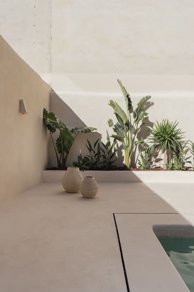 Architectural project - minimalist garden, muted palette, residential exterior, tropical plants, modern patio, contemporary landscape, summer retreat, desert vibes, zen garden, cream, minimal design, natural materials, relaxation area, outdoor space, natural light, sustainable design, neutral tones, beige, exterior design, eco friendly, simple design, leisure space, serene atmosphere, calming space, peaceful ambiance, clean lines, architectural simplicity, earthy tones, Mediterranean style, tranquil vibe, greenery, plaster walls, outdoor retreat, concrete floor, spa-like, indoor outdoor flow, light beige