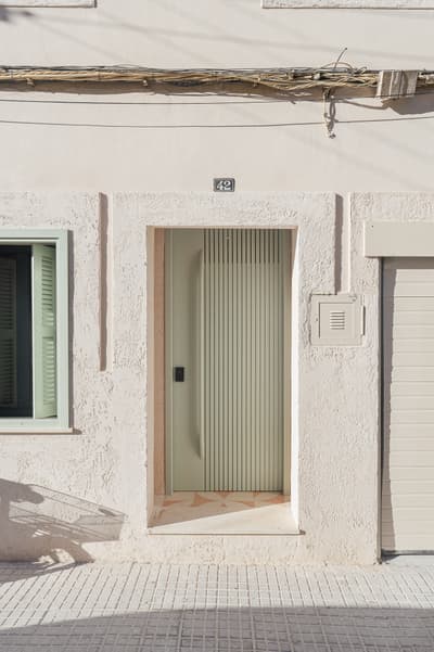 Architectural project - linear design, vertical lines, minimalist door, sleek look, geometric shapes, welcoming entrance, southern style, mint green, stucco wall, warm climate design, street facade, exterior renovation, pastel, passive design, green, beige, concrete, minimalist facade, contemporary design, neutral palette, pastel green, soft textures, light tones, modern facade, clean lines, white, home facade, architectural details, textured wall, plaster wall, energy efficient, plaster, Mediterranean style, subtle texture, sustainable facade, textured facade, soft tones, facade renovation, urban home, residential facade, urban exterior, entryway