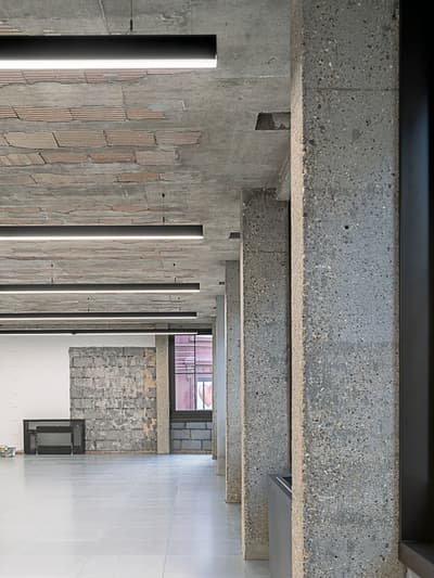 Architectural project - exposed concrete, industrial interior, raw aesthetic, industrial loft, contemporary office, modern renovation, concrete ceiling, modern loft, exposed brick, textured materials, loft conversion, polished floor, ceiling lights, brutalist design, modern space, unfinished space, concrete surface, grey tones, raw materials, industrial vibe, concrete, natural textures, neutral palette, minimalist design, adaptive reuse, industrial chic, creative space, workspace, open plan, spacious interior, grey floor, open space, structural elements, interior design, mixed materials, high ceiling, urban style, brick texture, urban vibe, urban interior