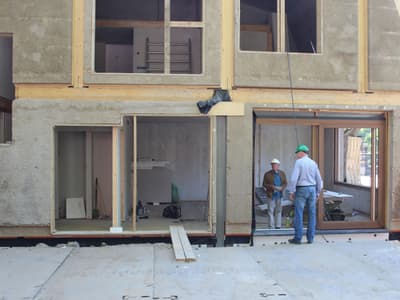 Architectural project - exposed timber, workshop, home build, energy conscious, natural materials, timber, raw materials, timber frame, natural light, sustainable design, glass, green building, grey, neutral tones, construction site, work in progress, construction workers, daylight, construction materials, building site, beige, concrete, light wood, eco friendly, sand, building process, unfinished building, residential construction, sustainable building, eco construction, prefab elements, circular construction, low carbon, passive house, large windows, indoor outdoor, energy efficient, plaster, plaster finish, wooden structure, straw bale, natural insulation