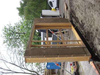 Architectural project - eco-friendly build, industrial process, natural materials, wood, timber, raw materials, timber frame, sustainable design, warm tones, modular construction, eco design, sustainable construction, green building, construction phase, building framework, structural timber, construction site, site work, outdoor construction, construction equipment, beige, wooden beams, sand, prefabricated structure, building process, eco construction, construction detail, natural palette, wood frame, energy efficient, earthy tones, gravel, low carbon building, wall assembly, insulation, building innovation, environment friendly