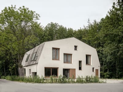 Architectural project - skylights, timber windows, quiet home, plaster facade, natural materials, wood, timber, sustainable design, warm tones, natural tones, beige, exterior design, minimalist facade, light wood, contemporary design, neutral palette, eco-friendly materials, green architecture, low carbon, biophilic design, sustainable home, passive house, natural ventilation, modern facade, landscape integration, modern minimalism, large windows, energy efficient design, plaster, green living, earthy tones, sloped roof, woodland setting, nature integration, forest house, eco house, residential building, modern home, suburban home, innovative architecture, eco conscious design