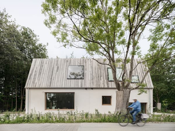 Architectural project - modern farmhouse, eco-friendly house, plaster facade, retreat house, natural materials, serene environment, sustainable materials, wood, timber, natural light, sustainable design, eco design, simple structure, grey, daylight, beige, light wood, modern aesthetic, rustic vibe, outdoor, Scandinavian style, minimalist design, neutral colors, exterior, tranquil setting, green architecture, biophilic design, passive house, landscape integration, large windows, timber cladding, wood cladding, Nordic design, countryside home, plaster, sloped roof, nature connection, rural setting, residential architecture, countryside retreat, gabled roof, family home, textured facade, urban escape, earthy textures, cozy home, rural house, picture windows
