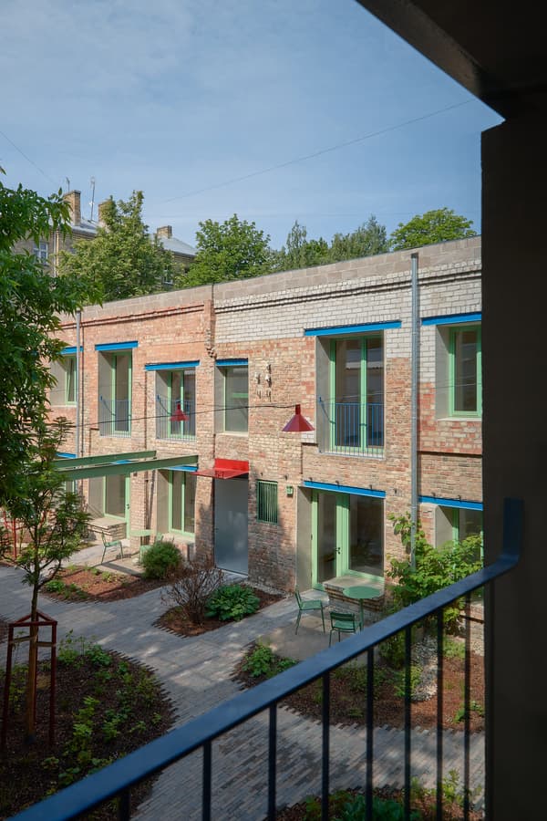 Architectural project - urban greenery, apartment facade, urban residence, residential complex, red accents, colorful facade, city garden, metal railings, natural lighting, brick exterior, brick material, balcony view, courtyard view, city courtyard, green doors, lush courtyard, yellow windows, garden setting, shared outdoor, community living, inviting courtyard, exterior renovation, multi-family housing, metal, sustainable design, yellow, glass, contemporary architecture, grey, green, blue, eco friendly, urban oasis, social space, outdoor seating, vibrant colors, blue sky, energy efficient, earthy tones, brick, brick facade, lush garden, open air, outdoor retreat, patio furniture, green space, urban living, brick texture, red, modern residential, outdoor terrace