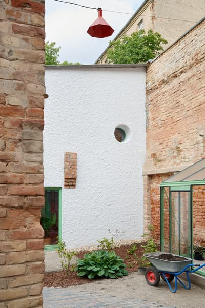 Architectural project - city garden, urban renewal, brick wall, exposed brick, courtyard design, historic building, light green, small garden, heritage site, garden courtyard, plaster facade, paved path, brick detail, green greenhouse, cozy garden, brick and plaster, serene corner, nature in city, warm brown, circular window, intimate space, outdoor space, outdoor living, sustainable design, recycled materials, compact space, urban oasis, natural textures, rustic charm, adaptive reuse, green architecture, white facade, white, earthy tones, garden design, terracotta, rustic wall, eco friendly space, red brick, rustic exterior, urban escape, urban nature, urban garden, mixed materials, texture contrast, urban retreat