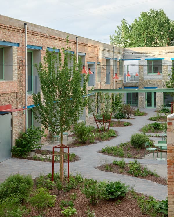 Architectural project - residential complex, red accents, community garden, modern renovation, brick wall, open sky, exposed brick, landscaped garden, balcony view, urban courtyard, paving stones, residential courtyard, open courtyard, sustainable courtyard, stone path, public green, contemporary housing, courtyard garden, plant beds, natural materials, tranquil space, metal, outdoor space, natural light, passive design, grey, green, daylight, brown, industrial style, eco friendly, modern design, urban oasis, industrial touch, neutral palette, social space, outdoor seating, earth tones, stone, brick, brick facade, greenery, green design, calm atmosphere, lush greenery, modern exterior, eco renovation, garden space, urban living, communal space