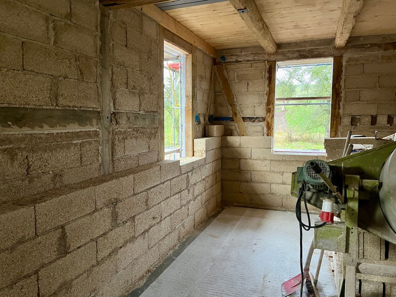 Architectural project - open ceiling, DIY construction, ambient light, rustic beams, spacious room, renovation project, rustic construction, warm interior, wood, timber, natural light, glass, warm tones, sustainable construction, neutral tones, timber structure, work in progress, exposed beams, daylight, beige, brown, concrete, timber beams, natural textures, eco materials, cozy space, unfinished interior, natural building, building materials, biophilic design, large windows, rustic style, earthy tones, environmental design, eco renovation, natural insulation