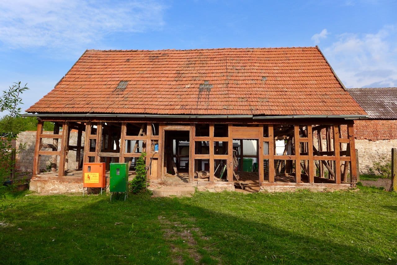 Architectural project - rural landscape, rustic, rural building, farm building, historical charm, restoration, terracotta roof, pastoral setting, historical building, renovation project, half-timbered house, natural materials, wood, timber, outdoor space, timber frame, warm tones, timber structure, exposed beams, brown, open structure, rustic vibe, vernacular architecture, weathered wood, rustic charm, countryside home, wood frame, traditional architecture, terracotta, brick, rustic facade, rural setting, greenery, traditional style, barn style, red