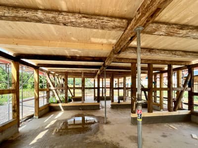 Architectural project - green construction, countryside style, timber posts, restoration, wood columns, renovation project, rustic construction, natural materials, wood, timber, raw materials, recycled materials, eco design, construction phase, building framework, timber structure, structural timber, construction site, under construction, exposed beams, open frame, wooden ceiling, timber facade, light wood, natural wood, eco friendly, wooden beams, rural architecture, honey wood, sustainable structure, unfinished building, natural building, eco build, indoor outdoor, timber cladding, timber ceiling, structural integrity, rustic style, earthy tones, heritage building, barn style, open space, daylighting