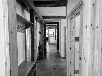 Architectural project - farmhouse modern, wood frames, rustic hallway, corridor design, country style, classic style, warm interior, natural materials, architectural detail, wood, timber, neutral tones, exposed beams, light wood, natural wood, compact space, simple design, wood beams, timber beams, natural textures, rustic charm, neutral palette, raw wood, modern rustic, wood detailing, cozy vibe, textured wall, plaster wall, inviting entrance, timber accents, plaster, open plan, earthy tones, warm atmosphere, traditional touch, stone floor, cozy home, interior design, welcoming space, minimalist hallway, home renovation, residential hallway, hallway design, interior corridor