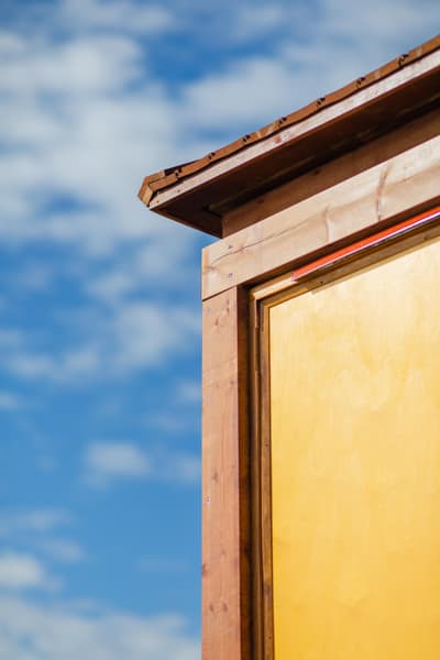 Architectural project - residential exterior, siding detail, house detail, sky background, exterior aesthetics, natural materials, architectural detail, wood, timber, eco design, contemporary style, sustainable architecture, neutral tones, wood facade, architectural photography, blue, timber construction, honey wood, minimalist architecture, light brown, minimalist design, blue sky, warm wood, low carbon, modern facade, clean lines, wood texture, warm ambiance, timber siding, inviting exterior, craftsmanship, honey tones, facade design, wooden exterior, smooth finish, wood panel, seamless design, exterior cladding