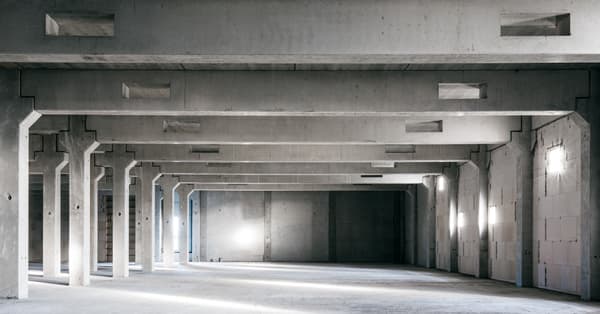 Architectural project - exposed concrete, flexible space, warehouse style, modern industrial, industrial interior, loft style, commercial space, unfinished look, airy interior, rugged texture, concrete texture, concrete walls, concrete interior, brutalist design, brutalism, large space, grey tones, utilitarian design, natural light, exposed structure, contemporary architecture, grey, neutral tones, functional space, daylight, industrial vibe, concrete, minimalist vibe, neutral palette, minimalist design, structural beams, white, raw finish, interior, urban architecture, public building, industrial space, structural rhythm