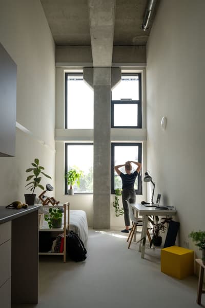Architectural project - modern apartment, exposed concrete, gray, loft style, concrete ceiling, cozy workspace, minimalist furniture, light filled room, office chair, compact room, relaxed environment, city apartment, natural light, glass, space-saving design, green, neutral tones, daylight, concrete, light wood, industrial style, multifunctional space, eco friendly, contemporary design, white walls, white, small space, cozy atmosphere, greenery, Scandinavian design, home office, study area, simple decor, sustainable living, work desk, minimalist interior, indoor plants, urban living, urban vibe, bright room, practical layout