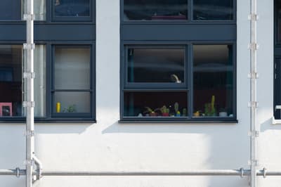 Architectural project - apartment facade, facade, industrial detail, windows, city view, smooth surface, black accents, architectural detail, metal frame, city living, contemporary architecture, grey, neutral tones, building facade, exterior wall, outdoor, industrial touch, minimalist design, black, exterior, geometric design, modern facade, clean lines, white, window view, modern architecture, plaster wall, plaster finish, exterior view, residential building, modern living, structural elements, urban architecture, residential facade, urban facade, urban living, urban view