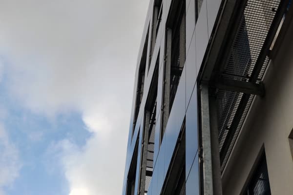 Architectural project - facade, vertical lines, clouds, sunlight reflection, metal structure, exterior facade, urban skyline, passive solar design, grid pattern, sleek facade, structural frame, architectural detail, industrial design, steel, sustainable design, glass, grey, neutral tones, urban environment, city architecture, building facade, blue, glass panels, minimalist design, urban design, blue sky, geometric design, modern aesthetics, modern facade, white, structural element, reflective surface, sky view, urban architecture, facade texture, modern urban, eco facade, contemporary building, high-rise building