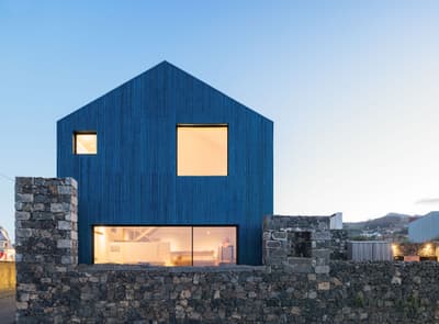 Architectural project - natural stone, clean architecture, harmony with nature, exposed stone, minimalist house, blue cladding, basalt stone, landscape, horizontal windows, blue facade, uniform color, rural landscape, open surroundings, contrast materials, architectural clarity, basalt, passive solar design, natural light, sustainable design, glass, grey, blue, eco friendly, natural setting, peaceful setting, minimalist architecture, contemporary design, large windows, countryside home, outdoor view, energy efficient, stone wall, quiet retreat, rural setting, barn style, residential building, textured facade, sleek design, home design, modern rural, simple lines, modern exterior, glass facade, rural house, picture window, modern house, geometric form