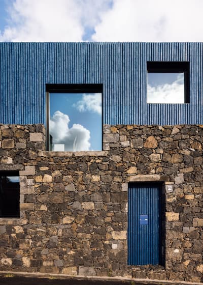 Architectural project - stone facade, natural stone, exterior contrast, minimalist house, blue cladding, basalt stone, basalt, textured stone, textured cladding, geometric windows, smooth texture, glazed windows, rustic elegance, dark stone, volcanic stone, black tones, climate responsive, natural materials, grey tones, blue tones, passive design, urban landscape, sustainable architecture, grey, exterior wall, low carbon design, blue, eco friendly, modern design, facade detail, Scandinavian style, black, natural finish, contemporary home, large windows, modern architecture, Nordic style, energy efficient, rough texture, stone wall, minimalist exterior, vertical cladding, facade design, modern exterior, architectural harmony, architectural rhythm, architectural contrast, urban home, reflective glass, residential facade, square windows, eco facade, stone texture