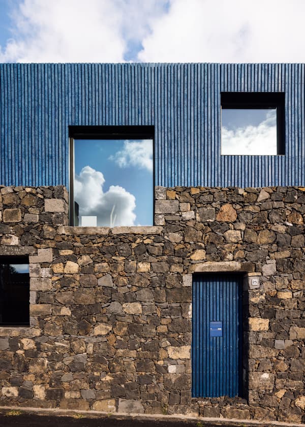 Architectural project - stone facade, natural stone, exterior contrast, minimalist house, blue cladding, basalt stone, basalt, textured stone, textured cladding, geometric windows, smooth texture, glazed windows, rustic elegance, dark stone, volcanic stone, black tones, climate responsive, natural materials, grey tones, blue tones, passive design, urban landscape, sustainable architecture, grey, exterior wall, low carbon design, blue, eco friendly, modern design, facade detail, Scandinavian style, black, natural finish, contemporary home, large windows, modern architecture, Nordic style, energy efficient, rough texture, stone wall, minimalist exterior, vertical cladding, facade design, modern exterior, architectural harmony, architectural rhythm, architectural contrast, urban home, reflective glass, residential facade, square windows, eco facade, stone texture