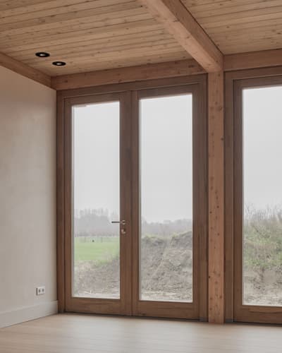 Architectural project - warm vibes, light filled room, natural view, seamless connection, cozy interior, warm interior, calming atmosphere, natural materials, eco-friendly design, wood, natural light, rustic touch, sustainable design, warm tones, natural tones, sustainable architecture, neutral tones, exposed beams, daylight, beige, brown, modern design, honey wood, natural textures, Scandinavian style, minimalist design, serene space, warm wood, biophilic design, eco home, passive house, large windows, indoor outdoor, Nordic style, landscape view, energy efficient, earthy materials, plaster, timber ceiling, timber interior, inviting space, textured walls, minimalist space, bright interior, glass door, wooden frames, plaster walls, cozy vibes, wood ceiling, warm lighting, clean design, connection with nature, timber door, wooden door, wood interior