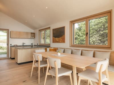 Architectural project - airy interior, family dining, cozy dining, wood table, wood chairs, cream, relaxing vibe, nature views, tranquil home, harmonious space, open kitchen, wood, timber, natural light, warm tones, eco design, daylight, beige, light wood, honey wood, rustic modern, natural textures, Scandinavian style, timber floor, wooden floor, neutral palette, calming space, modern rustic, biophilic design, sustainable home, contemporary home, large windows, Nordic design, beige tones, open layout, open plan, dining area, inviting space, warm atmosphere, casual dining, comfortable seating, residential space, bright interior, minimalist kitchen, modern kitchen, wood cabinetry, timber cabinetry, breakfast nook, interior, seamless transition, home interior, understated elegance