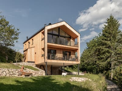 Architectural project - natural stone, retreat home, Scandinavian cabin, elevated design, natural materials, architectural design, wood, timber, outdoor living, sustainable design, natural tones, eco design, green, timber facade, daylight optimization, rustic modern, black, green architecture, modern rustic, eco home, sustainable home, passive house, natural ventilation, scenic view, large windows, wood cladding, cozy vibe, timber house, energy efficient, stone base, stone, pitched roof, landscape design, residential architecture, nature integration, countryside living, wooden house, green roof, modern cabin, rural retreat