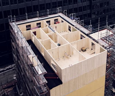 Architectural project - prefabricated, compact layout, natural materials, sustainable materials, wood, timber, scaffolding, cityscape, modular design, eco design, green building, neutral tones, construction site, under construction, urban development, urban environment, beige, brown, structural design, engineered wood, contemporary design, wood construction, timber building, innovative structure, timber panels, sustainable building, eco construction, CLT, cross laminated timber, circular construction, passive house, wood cladding, modern architecture, energy efficient, wooden facade, urban architecture, structural grid