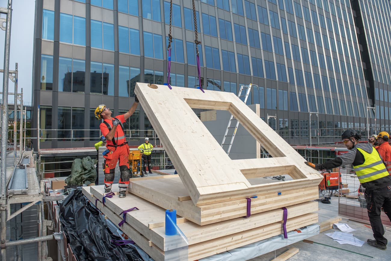 Architectural project - plywood panel, natural materials, sustainable materials, modular construction, prefabricated building, modular design, contemporary architecture, urban landscape, engineered timber, construction site, construction workers, urban construction, safety gear, assembly process, construction technique, urban development, teamwork, urban environment, building site, beige, light wood, low carbon design, innovative building, timber construction, eco materials, wood construction, sustainable building, eco construction, cross laminated timber, construction technology, modern architecture, engineering, prefabrication, structural panel, glass facade, wood panel, modern city, architectural innovation, high-rise building