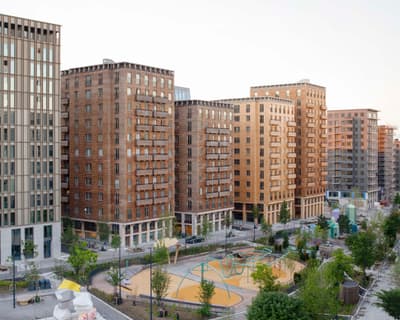 Architectural project - urban greenery, vibrant neighborhood, multi-story building, pedestrian friendly, urban renewal, urban regeneration, brown bricks, terracotta facade, skyline view, public amenities, eco-friendly design, city living, cityscape, sustainable construction, community space, city park, daylight optimization, contemporary design, light brown, public space, natural ventilation, modern architecture, energy efficient, earthy tones, terracotta, brick, brick facade, architectural rhythm, modern urban, integrated landscape, urban living