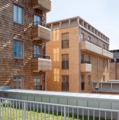 Architectural project - urban greenery, rooftop terrace, contemporary housing, community living, multi-family housing, eco-friendly architecture, wooden balcony, cladding detail, natural materials, timber, outdoor space, passive design, sustainable design, warm tones, beige, wood facade, timber facade, light wood, daylight optimization, honey wood, Scandinavian style, urban design, natural ventilation, landscape integration, energy efficient, cedar shingles, natural aesthetics, greenery, residential building, nordic influence, facade design, low carbon building, urban context, architectural harmony, texture contrast, urban housing, modern residential