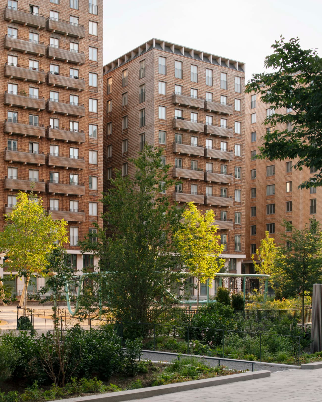 Architectural project - urban greenery, multi-story building, residential complex, vertical lines, urban residential, city oasis, natural materials, timber, city living, inviting atmosphere, passive design, sustainable design, warm tones, community space, outdoor area, urban landscape, contemporary style, green, neutral tones, urban development, neighborhood park, daylight optimization, eco friendly, green architecture, biophilic design, modern facade, timber accents, brick, brick facade, modern living, green space, urban garden, architectural rhythm, brown tones, urban retreat, urban neighborhood