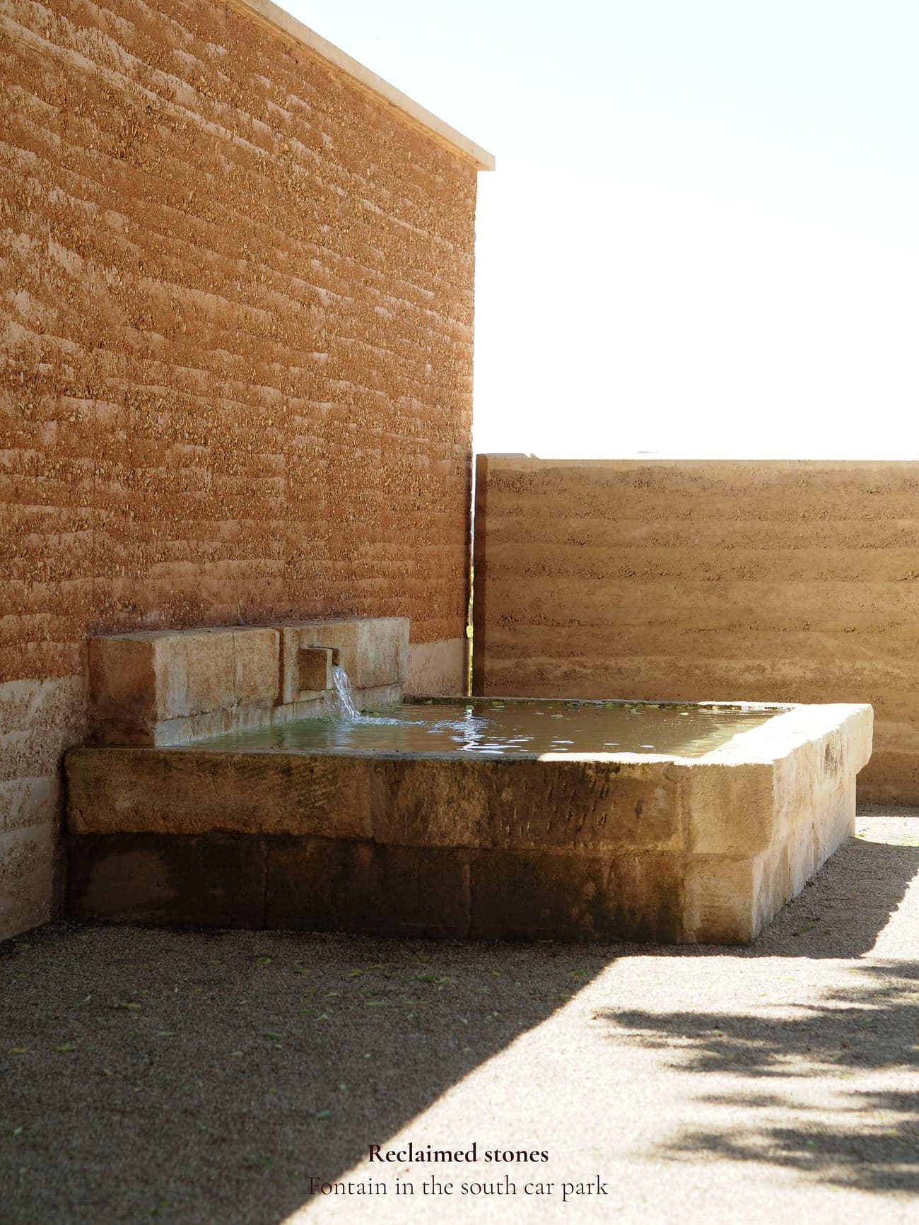 Architectural project - natural integration, rustic courtyard, rustic elegance, earthy aesthetic, simple landscaping, ecological architecture, minimalist landscape, stone fountain, courtyard fountain, outdoor fountain, reclaimed stone, desert vibes, arid landscape, zen garden, heritage materials, calming atmosphere, natural materials, sustainable design, warm tones, eco friendly, natural textures, organic design, neutral palette, serene space, passive cooling, rammed earth, green architecture, biophilic design, textured wall, stonework, earthy tones, environmental design, peaceful retreat, landscape design, water feature, outdoor retreat, outdoor relaxation, architectural feature