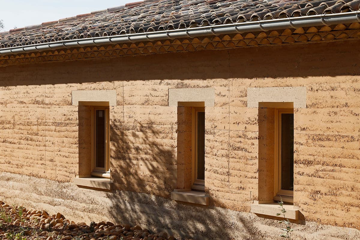 Architectural project - natural stone, rural landscape, homely feel, countryside vibe, tile roof, clay facade, stone foundation, historic influence, clay texture, contextual design, heritage style, warm environment, region-specific design, earth-colored, heritage-inspired, vernacular style, natural materials, sustainable materials, natural light, passive design, sustainable design, warm tones, sustainable architecture, beige, brown, exterior wall, eco friendly, rural architecture, vernacular architecture, organic design, rustic charm, natural finish, rammed earth, rammed earth wall, earthy texture, thermal mass, eco friendly home, rural home, stone, earthy tones, warm atmosphere, clay, pitched roof, rustic facade, traditional style, low impact, environmentally conscious, rural house