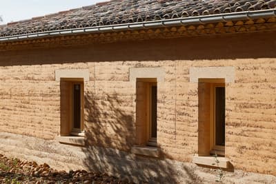 Architectural project - natural stone, rural landscape, homely feel, countryside vibe, tile roof, clay facade, stone foundation, historic influence, clay texture, contextual design, heritage style, warm environment, region-specific design, earth-colored, heritage-inspired, vernacular style, natural materials, sustainable materials, natural light, passive design, sustainable design, warm tones, sustainable architecture, beige, brown, exterior wall, eco friendly, rural architecture, vernacular architecture, organic design, rustic charm, natural finish, rammed earth, rammed earth wall, earthy texture, thermal mass, eco friendly home, rural home, stone, earthy tones, warm atmosphere, clay, pitched roof, rustic facade, traditional style, low impact, environmentally conscious, rural house