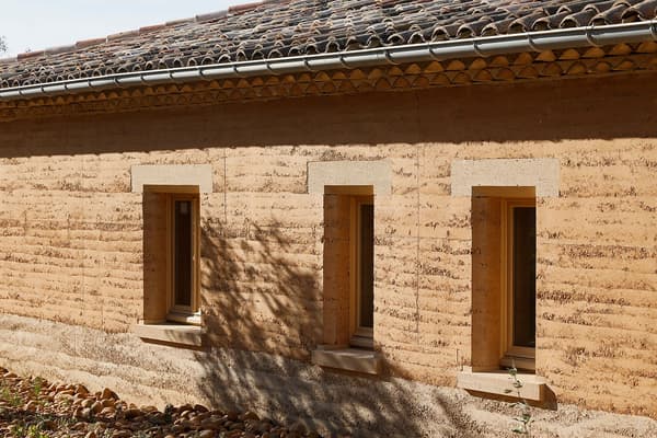 Architectural project - natural stone, rural landscape, homely feel, countryside vibe, tile roof, clay facade, stone foundation, historic influence, clay texture, contextual design, heritage style, warm environment, region-specific design, earth-colored, heritage-inspired, vernacular style, natural materials, sustainable materials, natural light, passive design, sustainable design, warm tones, sustainable architecture, beige, brown, exterior wall, eco friendly, rural architecture, vernacular architecture, organic design, rustic charm, natural finish, rammed earth, rammed earth wall, earthy texture, thermal mass, eco friendly home, rural home, stone, earthy tones, warm atmosphere, clay, pitched roof, rustic facade, traditional style, low impact, environmentally conscious, rural house