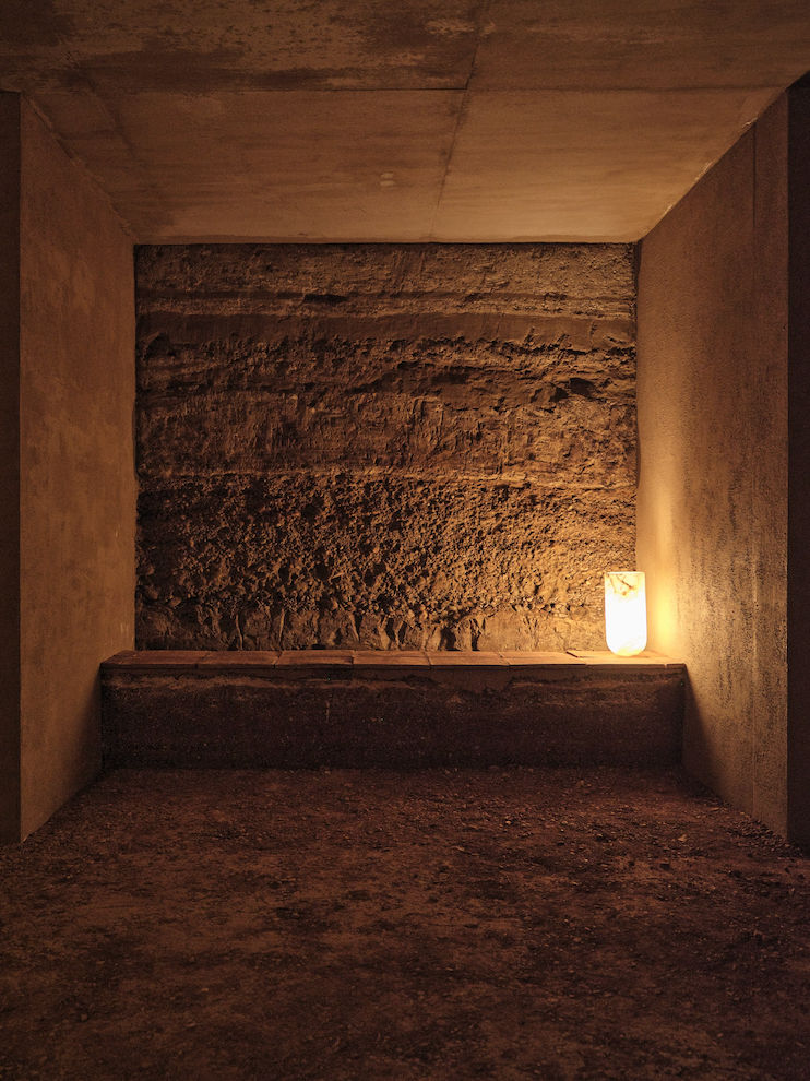 Architectural project - soft glow, ambient light, organic feel, earthy walls, earthy, mud wall, subtle lighting, cave-like room, earthy space, intimate nook, moody light, rammed wall, texture wall, raw interior, indigenous design, isolated space, meditative corner, recessed lighting, contemplative atmosphere, rich texture, earthen tones, peaceful nook, sanctuary vibe, enclosed room, natural aesthetic, atmospheric space, minimalist light, shelter-like, natural materials, eco-friendly design, passive design, sustainable design, beige, brown, calming space, rammed earth, earthen wall, natural material, thermal mass, earth tones, rustic texture, cozy vibe, warm ambiance, earthy tones, rustic design, nature-inspired, textured finish, eco house, minimalist space, warm lighting, clay wall, warm