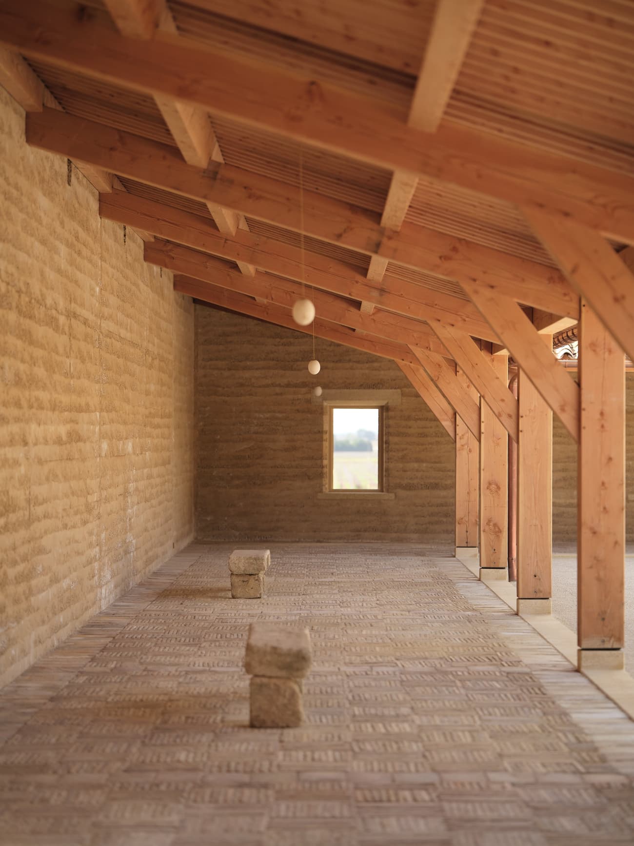 Architectural project - cozy feel, airy interior, rustic interior, rammed earth walls, earthen walls, adobe bricks, handmade look, red wood, natural materials, serene environment, raw materials, timber frame, natural light, warm tones, green building, sustainable architecture, renewable materials, daylight, eco friendly, wooden beams, rural architecture, rustic vibe, rustic charm, minimalist design, neutral colors, passive cooling, rammed earth, earthy texture, thermal mass, natural palette, timber roof, energy efficient, earthy vibe, earthy tones, exposed rafters, adobe, soft texture, rustic retreat, bright space, calm atmosphere, simple lines, bohemian vibe, warm palette, country home, vaulted ceiling, clay bricks, comfortable space
