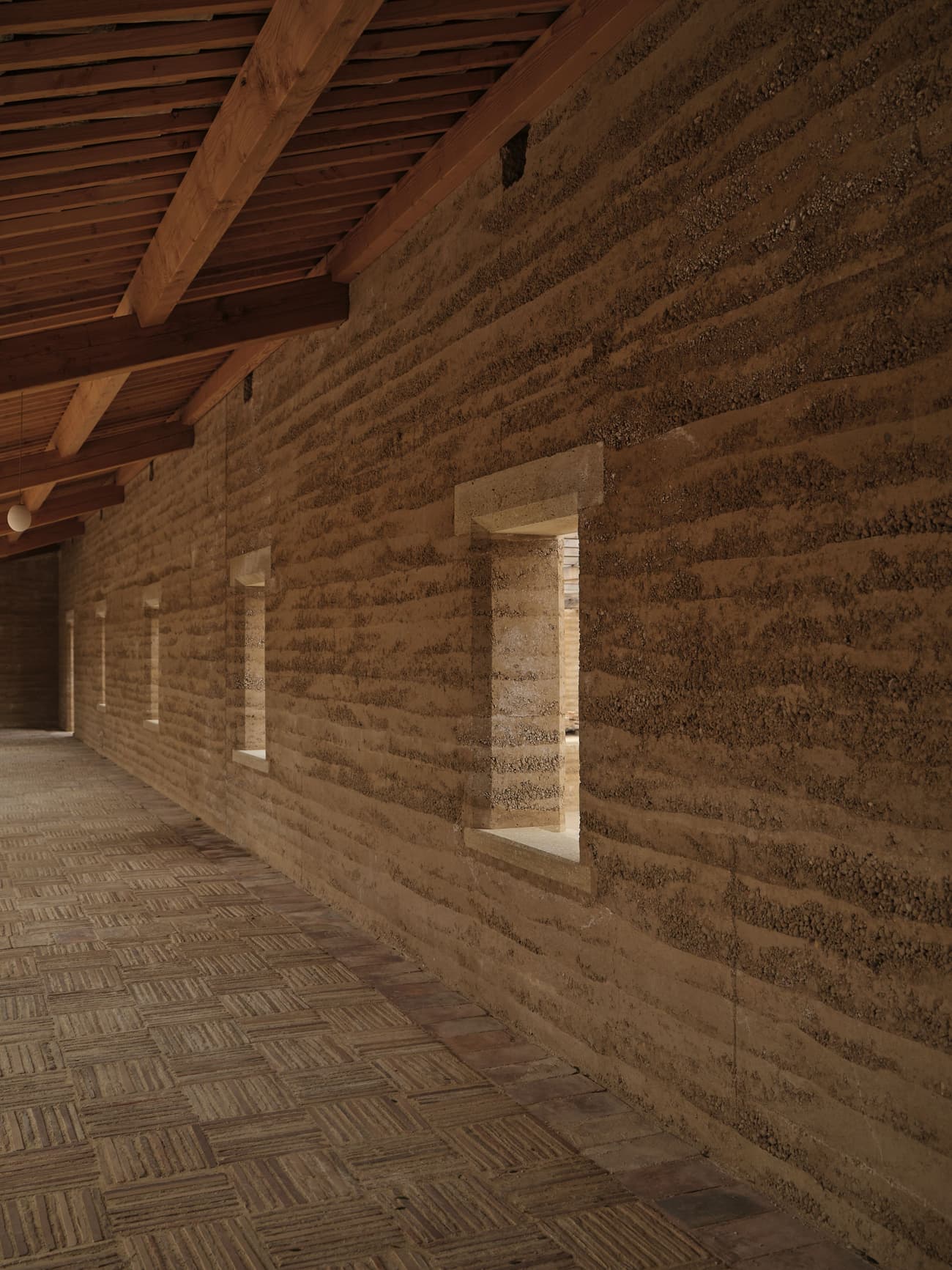 Architectural project - contemporary rustic, traditional craft, linear windows, strip windows, artisan feel, earthen colors, earthy architecture, countryside feel, tradition meets modern, warm interior, natural materials, wood, timber, raw materials, natural light, sustainable design, sustainable architecture, exposed beams, daylight, beige, brown, eco friendly, timber beams, organic design, rustic charm, neutral palette, cozy space, eco construction, natural building, rammed earth wall, earth tones, biophilic design, passive house, textured wall, beige tones, inviting space, earthy tones, warm atmosphere, rustic design, handcrafted, rural style, wooden roof, warm vibe, craftsmanship, earthy textures, modern nature, wood ceiling, sustainable living