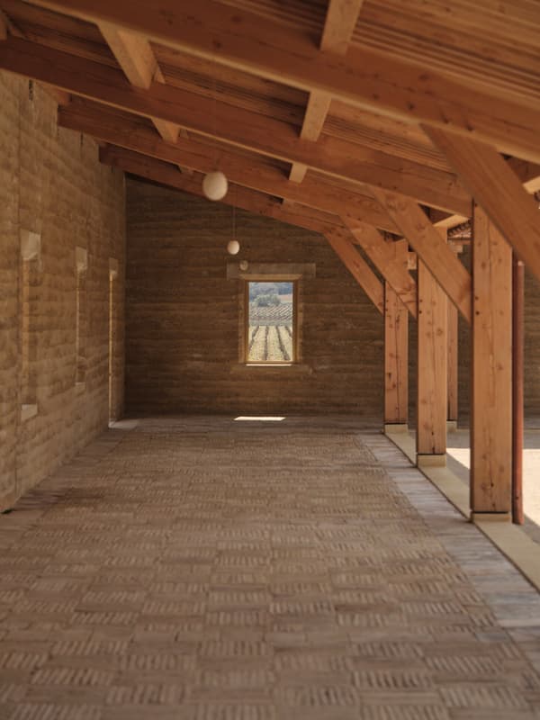 Architectural project - minimalistic design, rural building, agricultural building, barn conversion, natural design, countryside barn, rustic structure, clay masonry, artisanal textures, earthy, natural materials, eco-friendly design, wood, timber, timber frame, passive design, sustainable architecture, wooden ceiling, beige, wooden beams, farmhouse style, light brown, neutral palette, rammed earth wall, natural ventilation, clean lines, landscape view, countryside view, earthy tones, clay, exposed rafters, ventilated space, traditional craftsmanship, vernacular design, warm light, heritage architecture, earthy textures, open space, simple form
