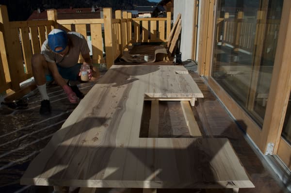Architectural project - terrace, balcony, mountain view, DIY project, workbench, outdoor workshop, natural elements, woodworking, wooden rails, refurbishing, wood, timber, outdoor space, natural light, sustainable design, warm tones, carpentry, beige, brown, light wood, natural setting, sunlight, honey wood, outdoor activity, relaxed atmosphere, tranquil setting, natural finish, eco-friendly materials, scenic view, rustic style, nature-inspired, cozy outdoor, craftsmanship, wooden deck, fresh air, timber railing, renovation