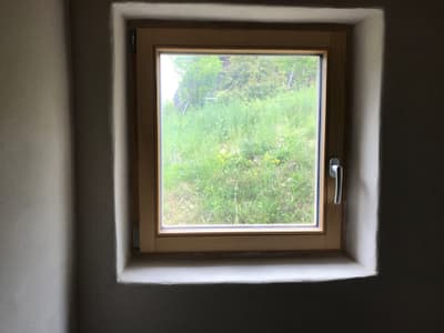 Architectural project - grass, hygge vibe, clear view, interior window, white wall, farmhouse vibe, simple window, square window, minimal design, cozy interior, wood, wooden frame, natural light, rustic touch, passive design, warm tones, green, neutral tones, daylight, eco friendly, natural textures, sustainable home, nature view, white, countryside home, landscape view, plaster wall, plaster, small space, earthy vibe, compact design, rustic style, nature connection, outdoor connection, rural charm, minimalist aesthetic, bright interior, window frame, energy efficiency, wooden accent