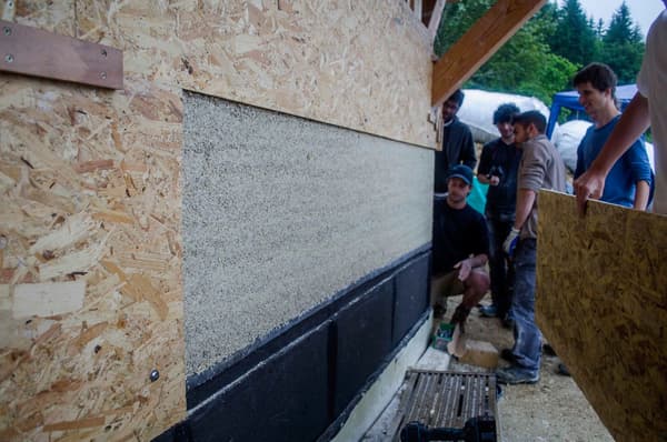 Architectural project - thermal insulation, community building, OSB board, OSB, wood building, carbon neutral, sustainable insulation, natural materials, wood, timber, recycled materials, natural tones, green building, neutral tones, construction site, outdoor construction, construction process, beige, exterior wall, low carbon design, building process, sustainable building, eco construction, circular construction, eco home, passive house, eco friendly home, energy efficient, environmentally friendly, timber framing, wooden structure, straw insulation, natural insulation, participatory design, collaborative building, wood panel, natural finishes