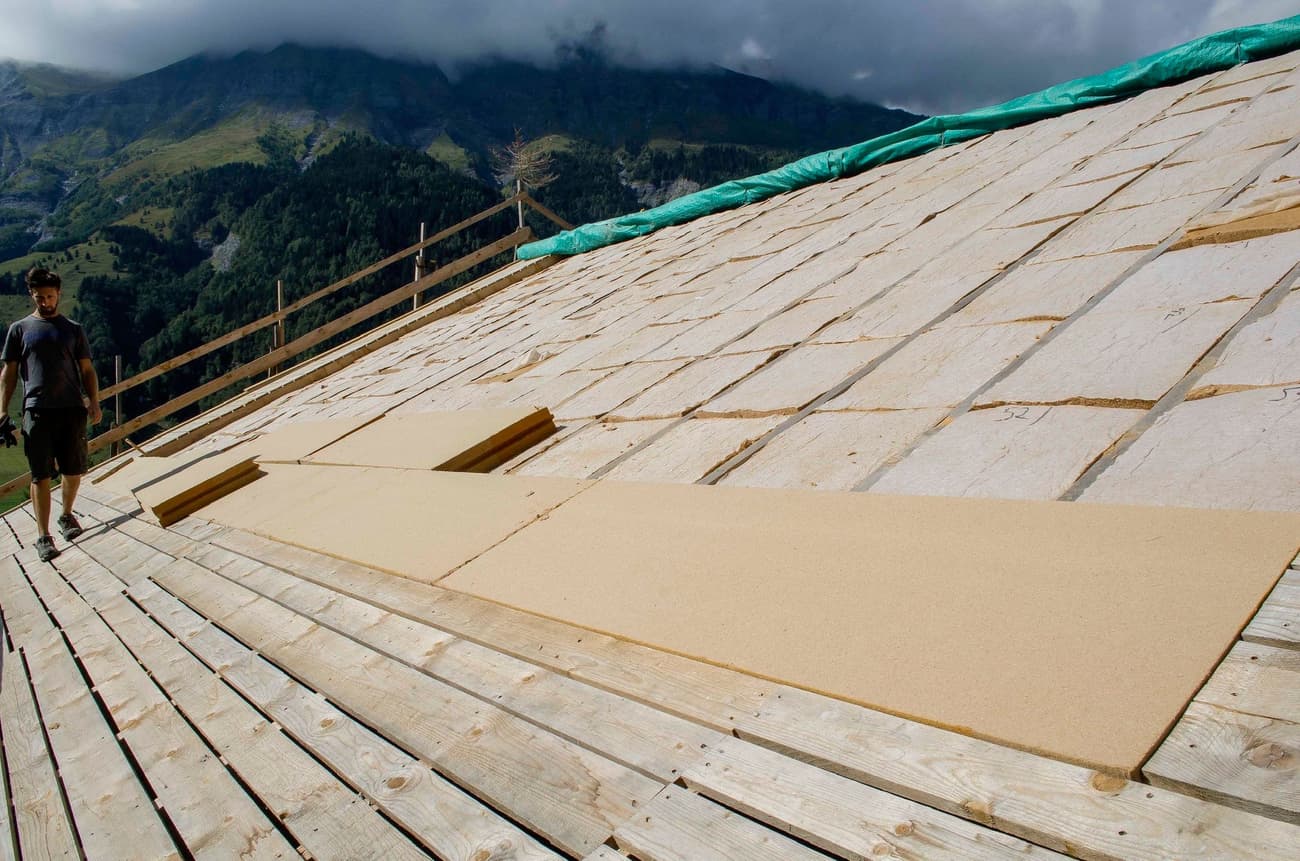 Architectural project - mountain view, green tarp, rustic setting, wooden planks, mountain backdrop, residential project, wood, timber, raw materials, outdoor space, passive design, sustainable design, natural tones, eco design, green building, green, construction site, modern construction, plywood, outdoor construction, construction process, building site, beige, brown, eco friendly, light brown, roof construction, natural landscape, timber roof, scenic view, panoramic view, sloped roof, pitched roof, wooden roof, environmental design, rural setting, natural environment, open space, timber decking, architectural process, home renovation