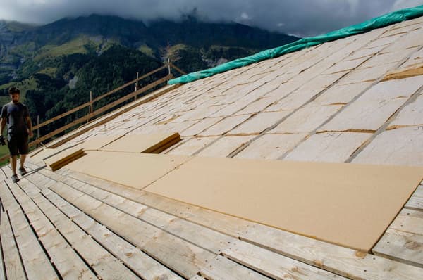 Architectural project - mountain view, green tarp, rustic setting, wooden planks, mountain backdrop, residential project, wood, timber, raw materials, outdoor space, passive design, sustainable design, natural tones, eco design, green building, green, construction site, modern construction, plywood, outdoor construction, construction process, building site, beige, brown, eco friendly, light brown, roof construction, natural landscape, timber roof, scenic view, panoramic view, sloped roof, pitched roof, wooden roof, environmental design, rural setting, natural environment, open space, timber decking, architectural process, home renovation