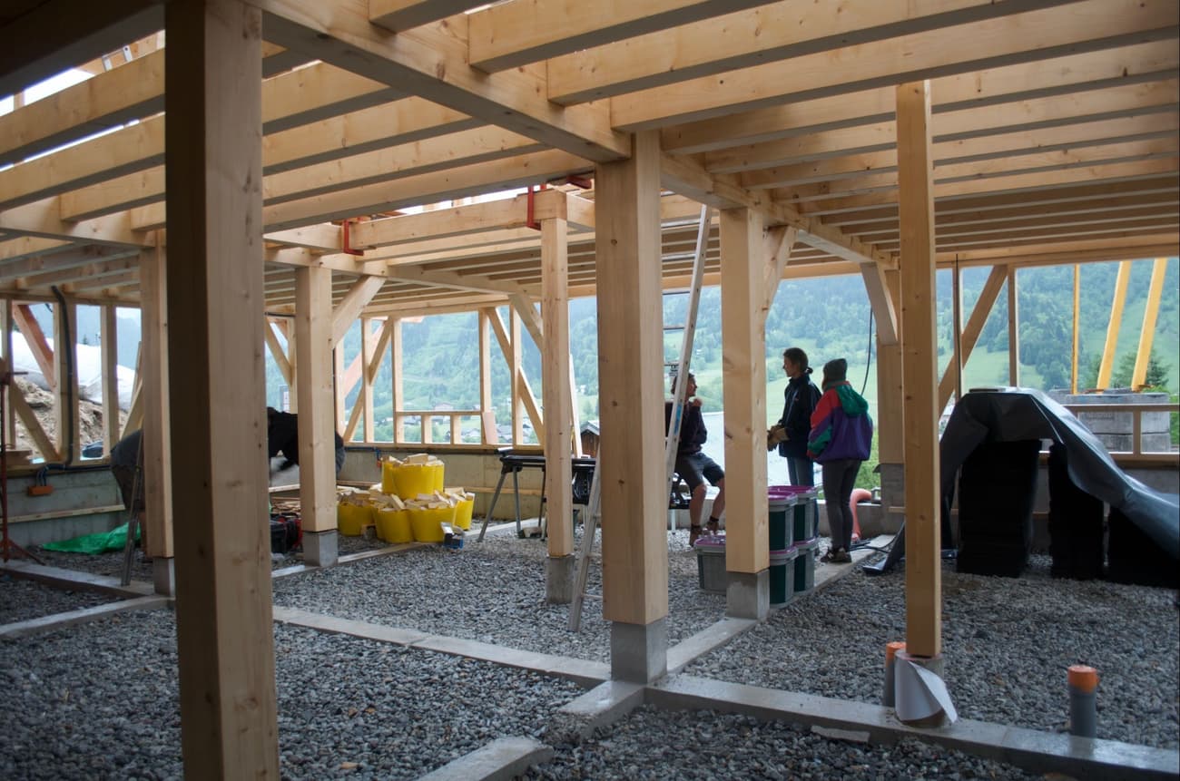 Architectural project - airy structure, airy interior, framework, indoor space, natural materials, wood, timber, raw materials, timber frame, natural light, passive design, glass, modular construction, green building, grey, neutral tones, construction phase, construction site, exposed beams, ventilation, modern construction, daylight, building site, wood framework, light wood, architectural framework, engineered wood, functional design, timber construction, honey wood, timber beams, eco-friendly construction, minimalist structure, sustainable building, eco construction, timber walls, timber architecture, light filled, timber ceiling, wood roof, wooden structure, gravel, open space, structural elements, wooden columns, wood interior, contemporary building, structural grid