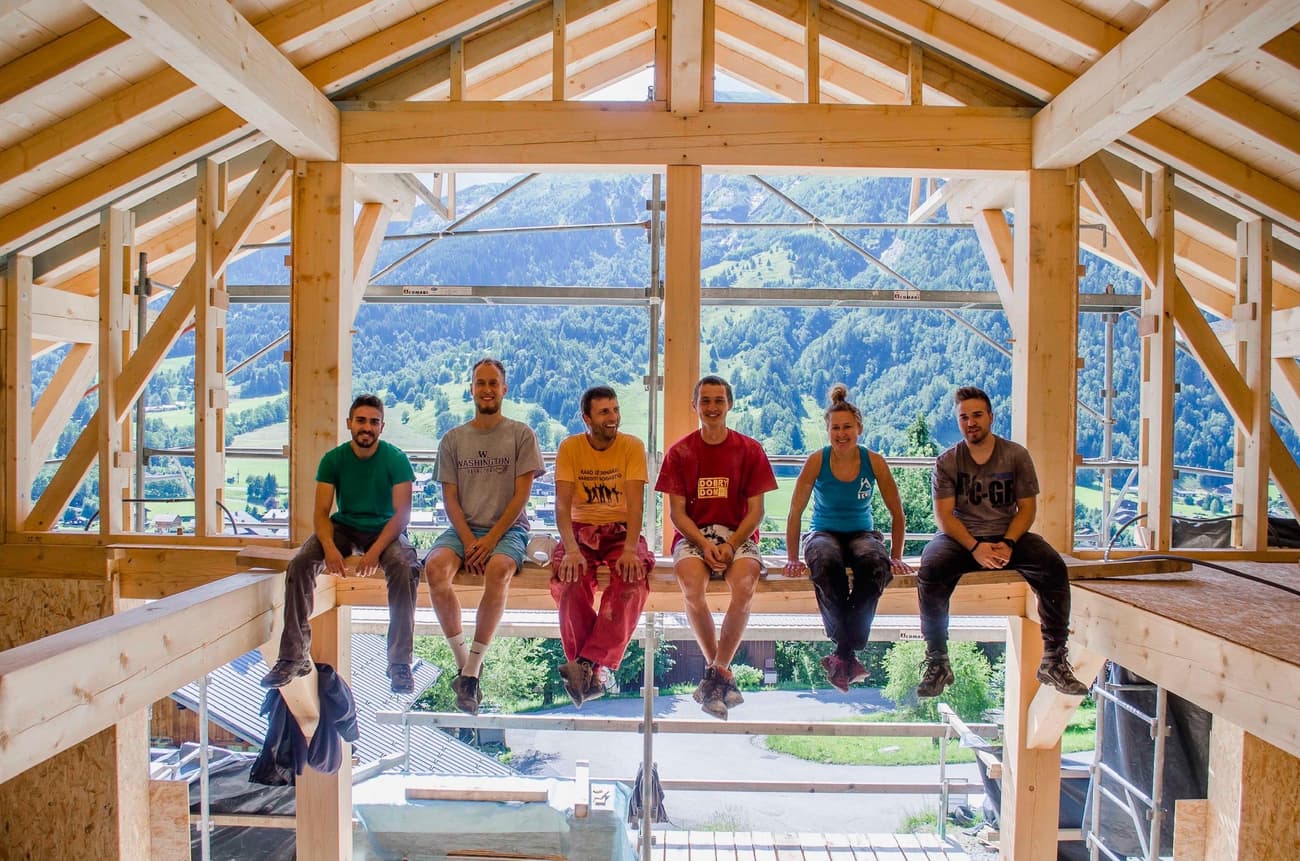 Architectural project - mountain view, passive solar design, timber rafters, natural materials, eco-friendly design, raw materials, timber frame, natural light, warm tones, sustainable construction, green building, construction phase, construction site, exposed beams, carpentry, daylight, light wood, natural wood, timber construction, rural architecture, honey wood, timber beams, building process, timber building, wood structure, unfinished interior, woodwork, eco build, modern rustic, passive house, natural ventilation, indoor outdoor, timber house, landscape view, airy space, rustic style, panoramic view, rural setting, countryside, structural elements, low carbon building, high ceiling