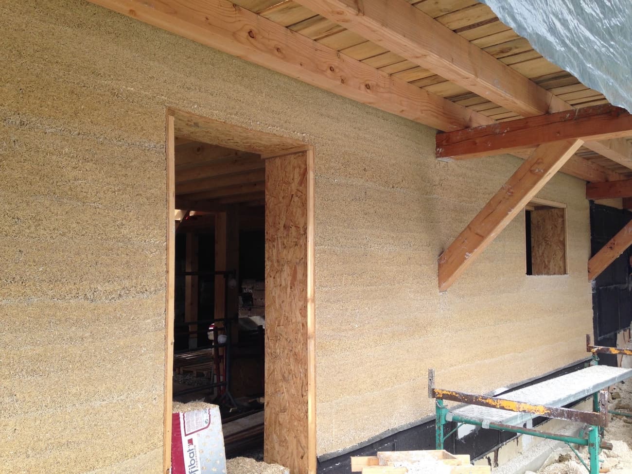 Architectural project - natural facade, thermal insulation, straw, warm facade, straw wall, rustic construction, natural materials, wood, timber, wooden frame, timber frame, natural light, eco design, sustainable construction, renewable materials, daylight, plywood, beige, eco friendly, farmhouse style, rural architecture, simple design, vernacular architecture, natural textures, organic design, rustic charm, light brown, unfinished building, timber elements, natural building, passive house, energy efficient, earthy tones, organic materials, rural style, rural setting, cozy exterior, wooden elements, rustic exterior, sustainable facade, honey tones, wooden structure, straw bale, warm palette