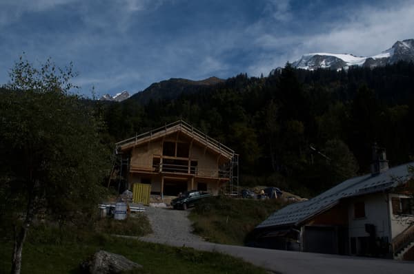 Architectural project - mountain retreat, remote living, natural backdrop, getaway cabin, retreat home, environmental integration, natural materials, wood, timber, scaffolding, outdoor living, passive design, sustainable design, warm tones, green building, beige, brown, timber facade, timber construction, rural architecture, serene atmosphere, exterior, warm wood, hillside house, scenic view, wood cladding, rural home, countryside home, rustic cabin, earthy tones, pitched roof, forest setting, nature retreat, gable roof, wooden facade, eco retreat, wooden structure, cozy vibes, construction, natural surroundings